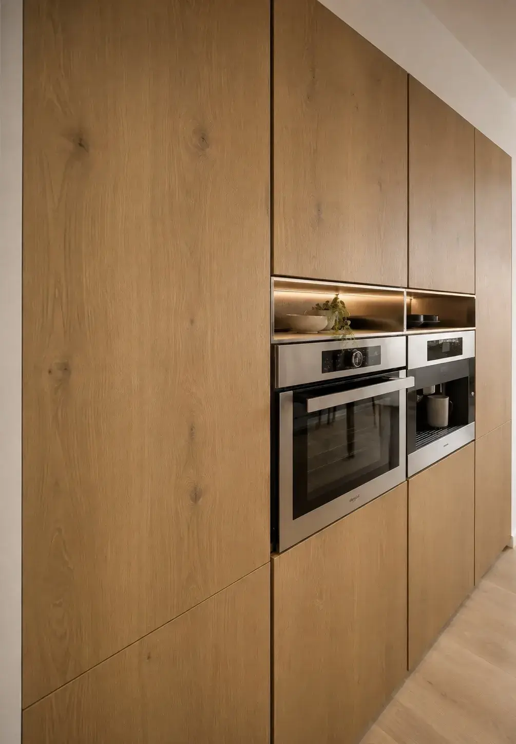 Wooden kitchen wall with an oven and a built-in coffee machine